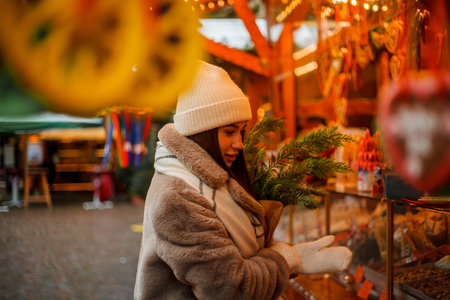 Happy young woman of European appearance at Christmas market in Germany. Festive city. Decor. New Year.の写真素材