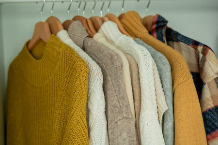 Warm autumn clothes knitted in the closet. Organization.の写真素材