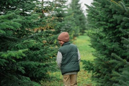 Portrait of cute boy choosing Christmas tree for home. Holidaysの写真素材