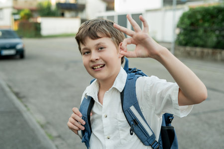 Portrait of a schoolboy with a backpack on the street. Back to school.