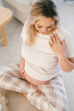 Portrait of a young pregnant woman at home.の写真素材
