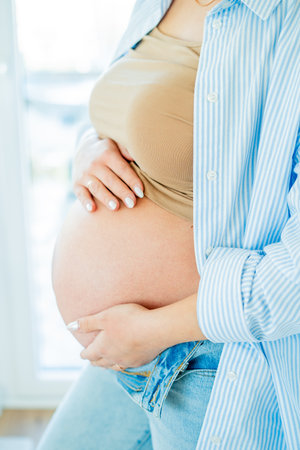 Young beautiful pregnant woman hugging her belly. motherhoodの写真素材