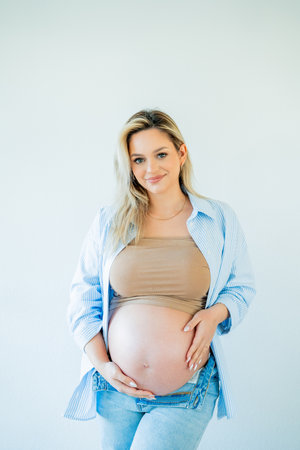 Young beautiful pregnant woman hugging her belly. motherhood