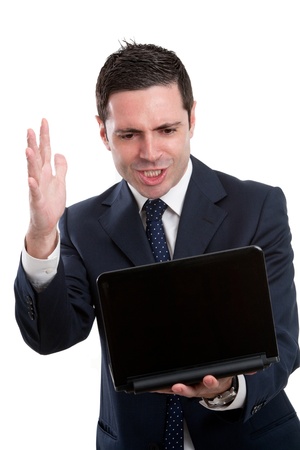 Portrait of frustrated and angry young business man in blue suit with laptop. Isolated on white.の写真素材