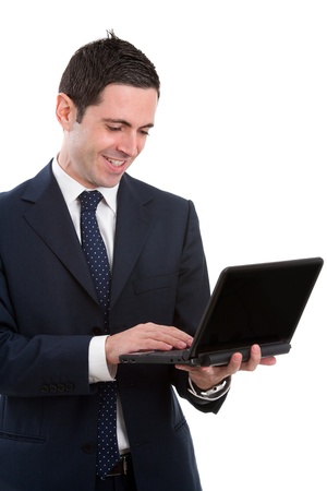Handsome young business man in blue suit working on laptop. Isolated on white.の写真素材
