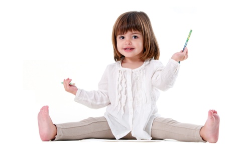 Portrait of cute little girl holding pencils. Isolated on white background.の写真素材