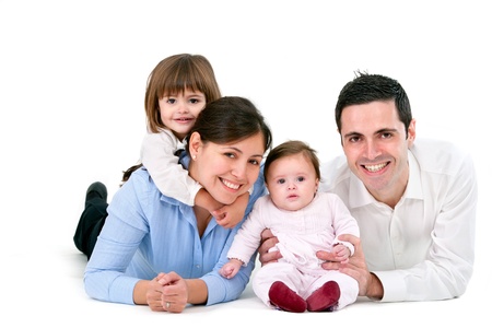 Portrait of young couple having fun with their daughters. Isolated on white background.の写真素材