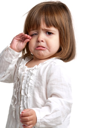 Portrait of litte girl crying. Isolated on white background.の写真素材