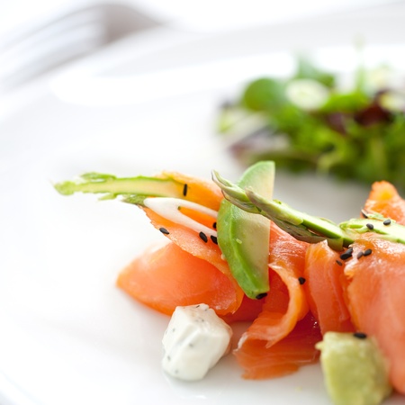 Close up of smoked salmon salad with green asparagus and avocadoの写真素材
