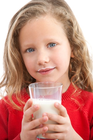 Close up Portrait of cute little girl holding glass of milk  Isolated on white background の写真素材