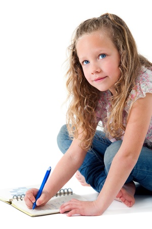 Portrait of cute blond girl doing homework  Isolated on white の写真素材
