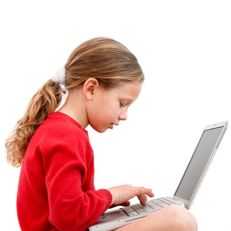 Cute blond girl doing homework with laptop  Isolated on white の写真素材