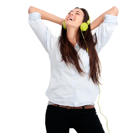 Young woman feeling happy listening music with headphones.Isolated.の写真素材