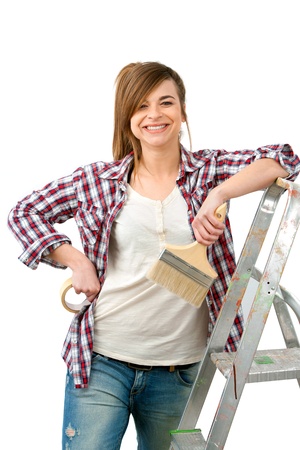 Portrait of cute female painter with brush ready to paint Isolated on white の写真素材