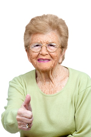 Close up portrait of friendly senior woman showing thumbs up Isolated on white の写真素材