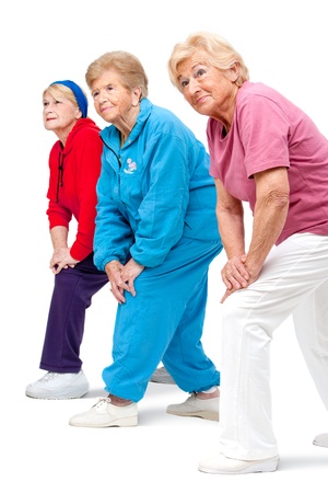 Threesome group of senior women doing stretching exercise Isolated on white の写真素材