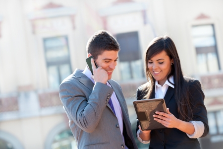 Young Business couple working outdoors with digital tablet.の写真素材