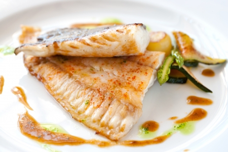 Close up of grilled brill fish with vegetables.の写真素材