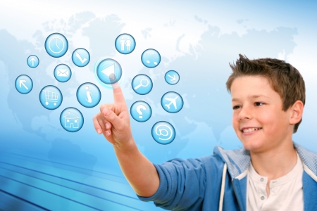 Portrait of Boy pointing at web icons with futuristic interface の写真素材