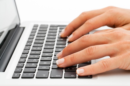 Macro close up of female hands on laptop keyboard の写真素材