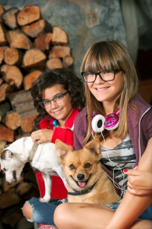 Close up portrait of cute teenage girlfriends with their dogs の写真素材