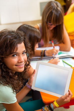 Portrait of cute student holding digital tablet with free copy space の写真素材