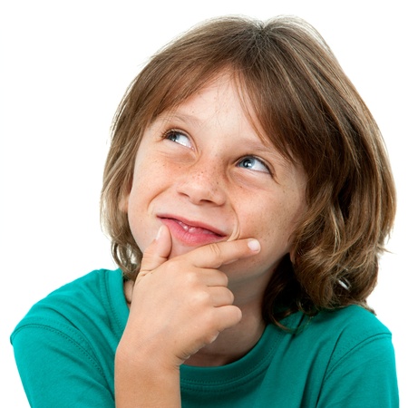Close up portrait of cute boy looking up at corner. Isolated on white.の写真素材
