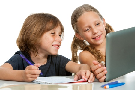 Close up portrait of cute girl showing classmate homework on tablet. Isolated.の写真素材
