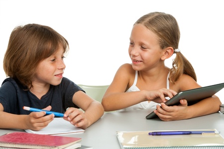 Portrait of two kids discussing homework at desk.Isolatedの写真素材