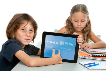 Close up portrait of boy student doing maths on digital tablet at desk の写真素材