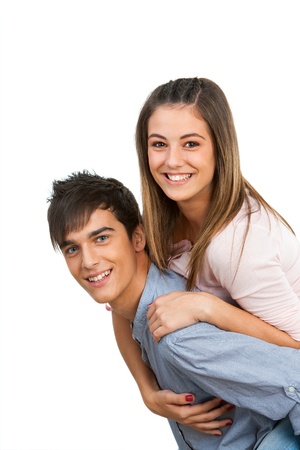 Close up of happy teen couple doing piggybacking.Isolated on white.の写真素材