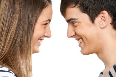 Close up portrait of teen couple facing each other.Isolatedの写真素材