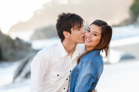 Close up of handsome teen couple in love on beach.の写真素材