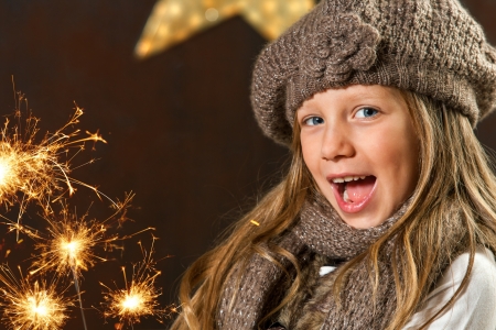 Close up portrait of girl having fun with fireworks の写真素材