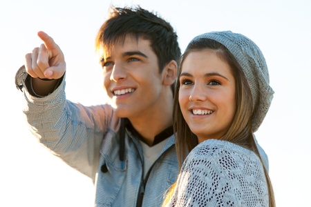 Close up outdoor portrait of boy showing girlfriend something in the distance.の写真素材