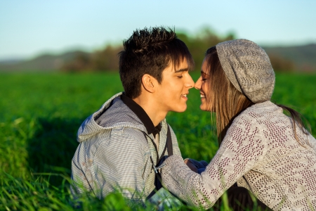 Close up portrait of young handsome couple in countryside showing affection.の写真素材