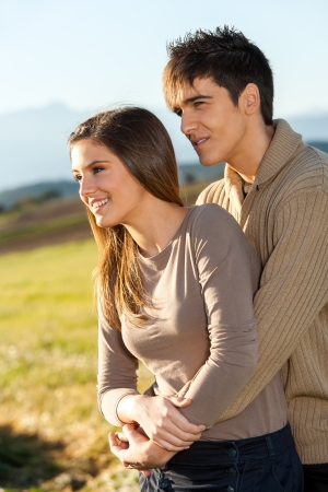 Portrait of young handsome couple outdoors in rural field.の写真素材
