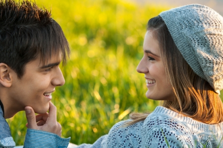 Close up portrait of young couple outdoors with in love face expression.の写真素材