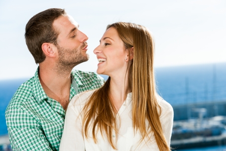 Close up portrait of young couple playing around outdoors.の写真素材