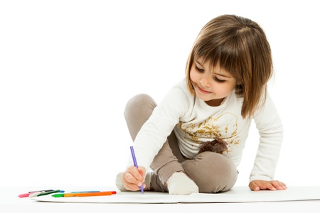 Portrait of little girl drawing with wax crayons.isolated on white.の写真素材