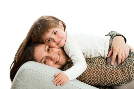 Portrait of young mother with daughter on couch.Isolated.の写真素材