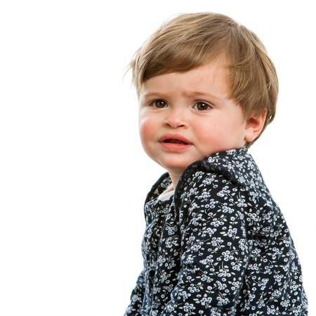 Close up portrait of toddler with confused face expression.Isolated.の写真素材