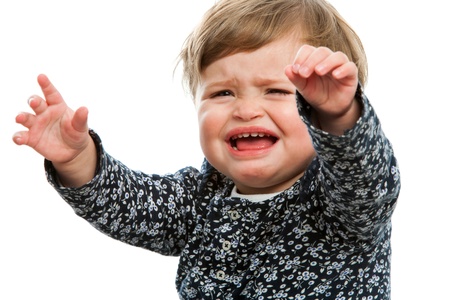 Close up portrait of unhappy toddler crying for attention.の写真素材