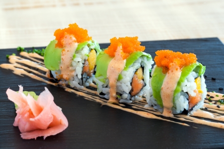 Close up of salmon and mango uramaki with avocado outside.の写真素材