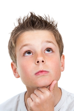 Close up face shot of cute boy looking up.Isolated on white.の写真素材