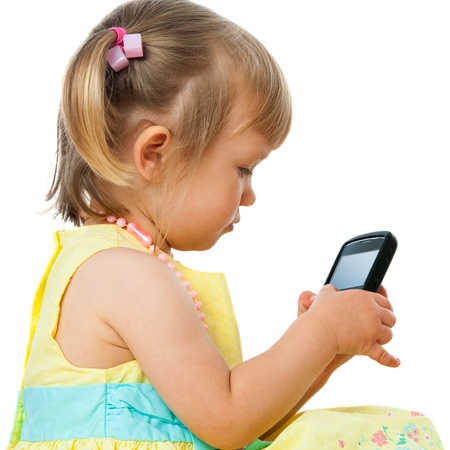Close up portrait of cute little girl navigating on cellular phone.Isolated on white.の写真素材