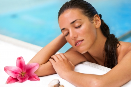 Close up portrait of attractive girl relaxing in spa pool.の写真素材