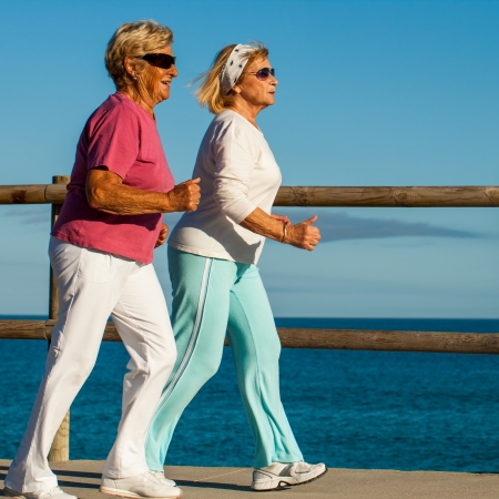 Action portrait of golden age women having early morning jog.の写真素材