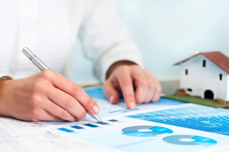 Female analyst reviewing home budget statistics の写真素材
