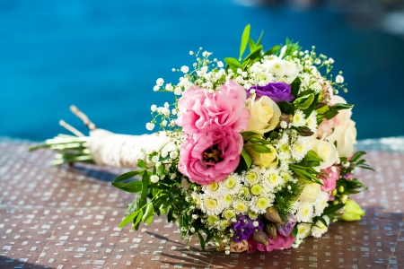 Colorful bridal flower bouquet outdoors with blue background.の写真素材